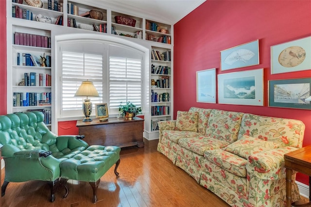 sitting room featuring wood finished floors and crown molding