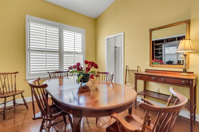 dining room with baseboards and wood finished floors