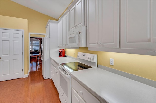 kitchen featuring white cabinets, light countertops, white appliances, and light wood finished floors
