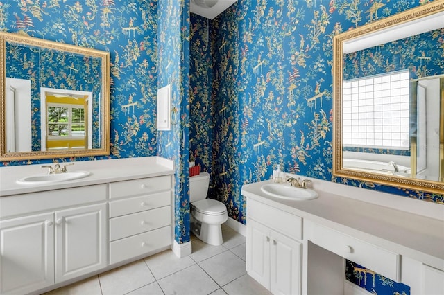 bathroom with a wealth of natural light, tile patterned flooring, vanity, and toilet