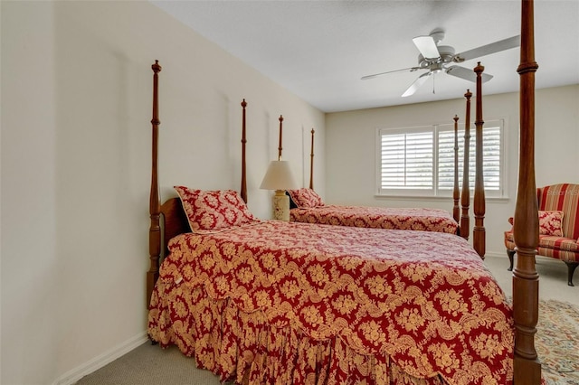 carpeted bedroom with a ceiling fan and baseboards