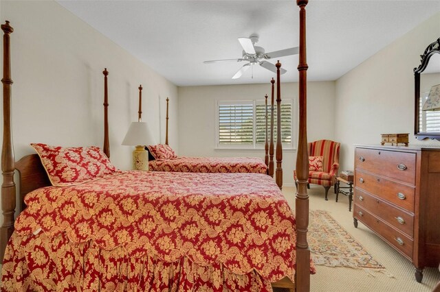 bedroom featuring light colored carpet and ceiling fan
