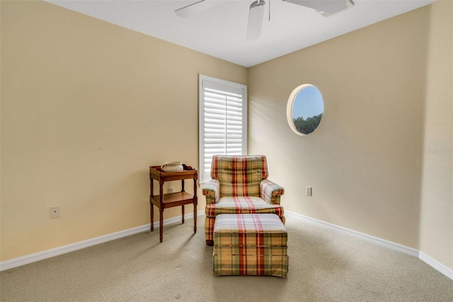 sitting room with baseboards, carpet flooring, and ceiling fan