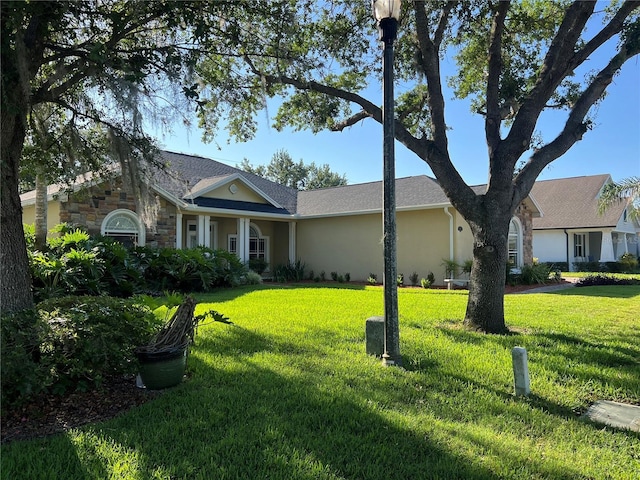 view of front of home with stucco siding and a front lawn