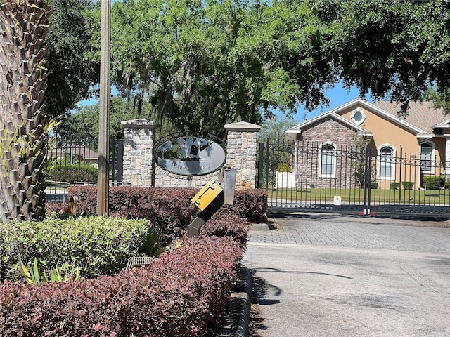 community sign with fence and a gate