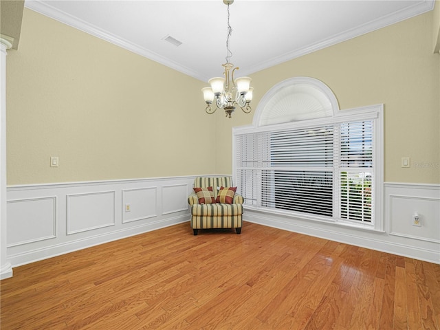 3300 Hawks Ridge Dr, Lakeland, FL 33810 - sitting room featuring a chandelier, ornamental molding, wainscoting, and light wood finished floors