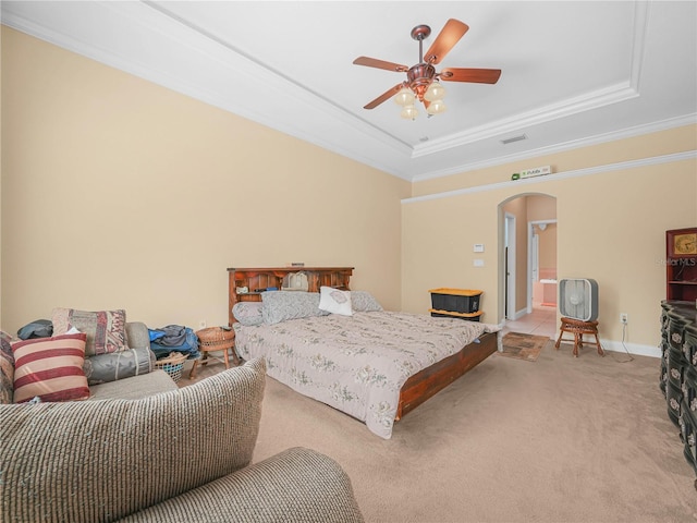 3300 Hawks Ridge Dr, Lakeland, FL 33810 - bedroom featuring arched walkways, a raised ceiling, light carpet, ornamental molding, and a ceiling fan
