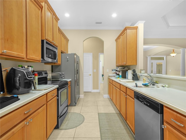 3300 Hawks Ridge Dr, Lakeland, FL 33810 - kitchen featuring stainless steel appliances, arched walkways, light countertops, and crown molding