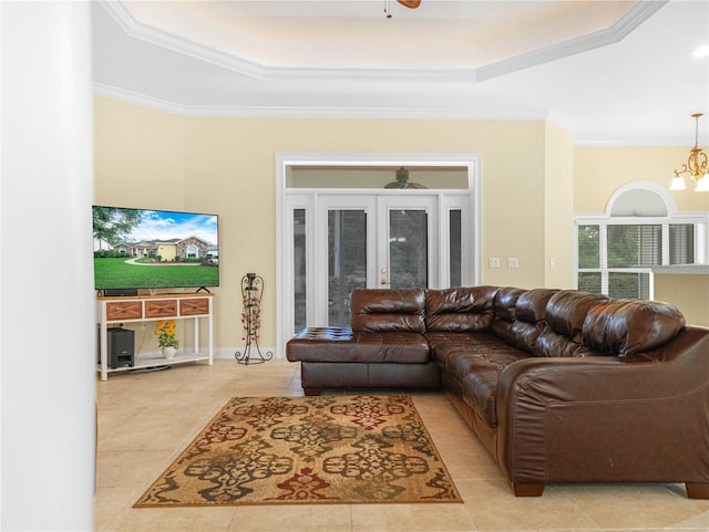 3300 Hawks Ridge Dr, Lakeland, FL 33810 - living room featuring a raised ceiling, crown molding, a chandelier, light tile patterned floors, and french doors