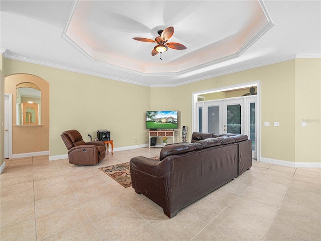 3300 Hawks Ridge Dr, Lakeland, FL 33810 - living room with a raised ceiling, light tile patterned flooring, a ceiling fan, ornamental molding, and arched walkways