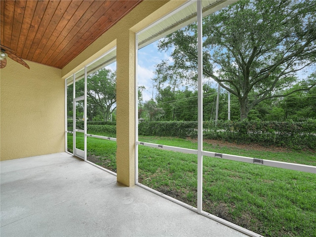 3300 Hawks Ridge Dr, Lakeland, FL 33810 - unfurnished sunroom featuring a textured wall, a ceiling fan, and wood ceiling