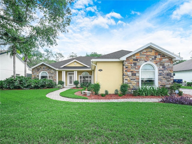 3300 Hawks Ridge Dr, Lakeland, FL 33810 - view of front facade featuring stucco siding, a front lawn, stone siding, and a shingled roof