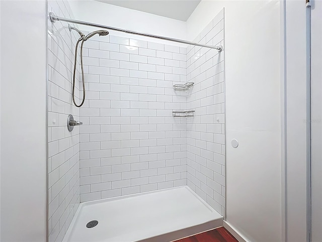 full bath featuring a shower stall and wood finished floors