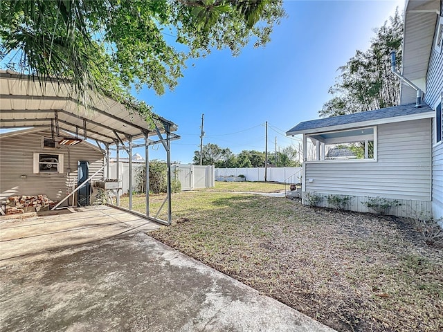 view of yard featuring a detached carport and fence