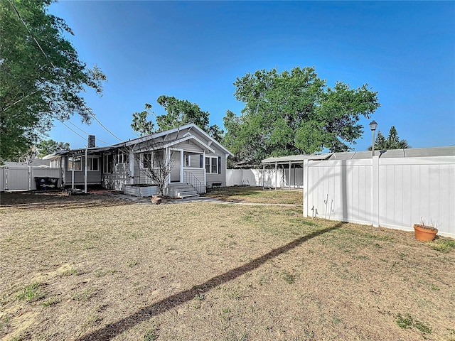view of yard featuring entry steps and a fenced backyard