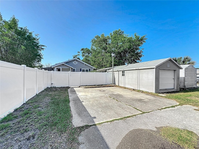 exterior space with a fenced backyard, a patio area, and an outdoor structure