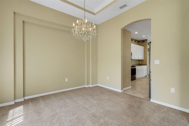 12301 Jim Edwards Rd, Haines City, FL 33844 - spare room with arched walkways, light carpet, a chandelier, recessed lighting, and baseboards
