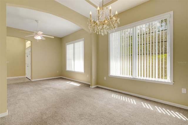 12301 Jim Edwards Rd, Haines City, FL 33844 - carpeted empty room with arched walkways, baseboards, ceiling fan, and a chandelier