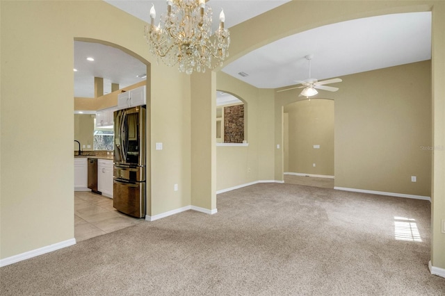 12301 Jim Edwards Rd, Haines City, FL 33844 - spare room featuring arched walkways, light colored carpet, a ceiling fan, and baseboards