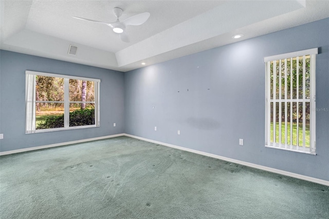 12301 Jim Edwards Rd, Haines City, FL 33844 - carpeted spare room featuring a tray ceiling, a ceiling fan, and baseboards