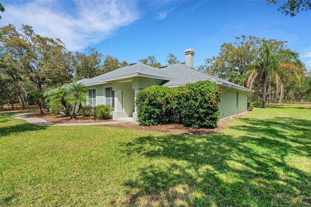 12301 Jim Edwards Rd, Haines City, FL 33844 - view of front facade featuring a front yard, a chimney, and stucco siding