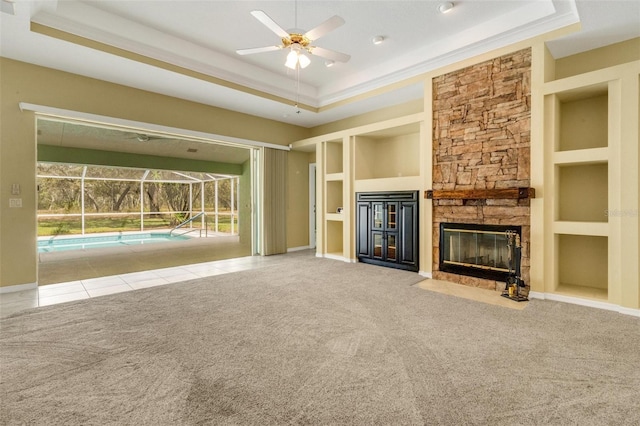 12301 Jim Edwards Rd, Haines City, FL 33844 - unfurnished living room with a raised ceiling, a fireplace, a ceiling fan, carpet, and ornamental molding