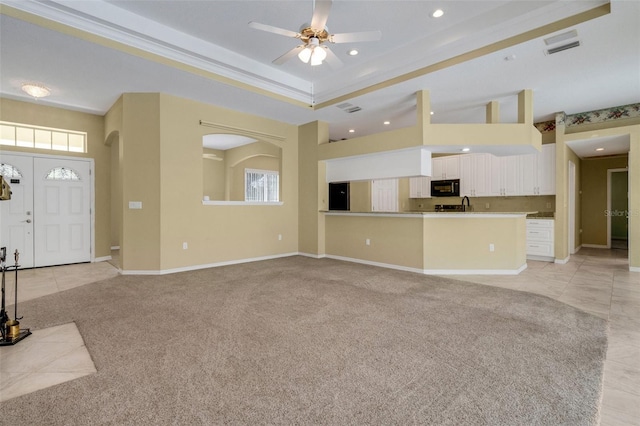 12301 Jim Edwards Rd, Haines City, FL 33844 - unfurnished living room featuring recessed lighting, plenty of natural light, a ceiling fan, light carpet, and a raised ceiling