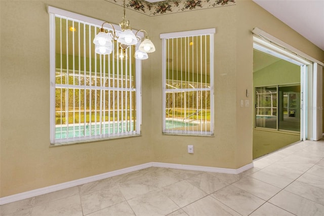 12301 Jim Edwards Rd, Haines City, FL 33844 - unfurnished dining area with a chandelier, plenty of natural light, and baseboards