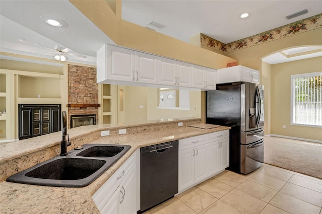 12301 Jim Edwards Rd, Haines City, FL 33844 - kitchen featuring dishwasher, a sink, ceiling fan, stainless steel fridge, and arched walkways