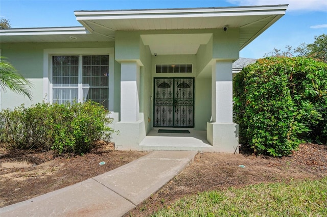 12301 Jim Edwards Rd, Haines City, FL 33844 - view of exterior entry with stucco siding and covered porch