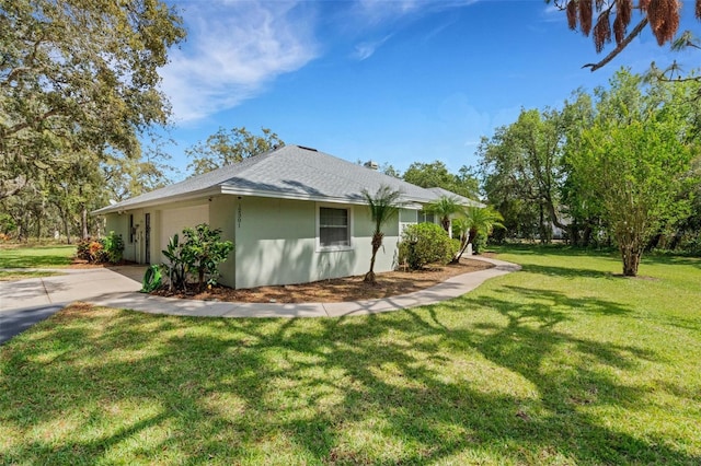12301 Jim Edwards Rd, Haines City, FL 33844 - view of side of property featuring an attached garage, stucco siding, driveway, a yard, and roof with shingles
