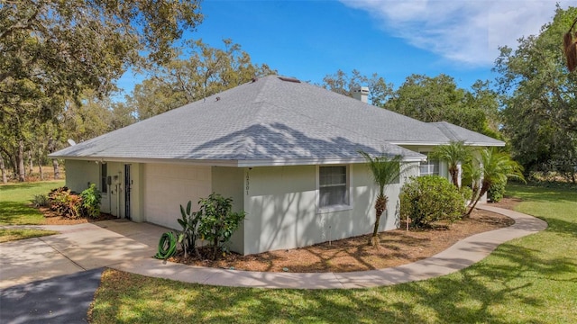12301 Jim Edwards Rd, Haines City, FL 33844 - view of home's exterior featuring roof with shingles, a chimney, a yard, an attached garage, and concrete driveway