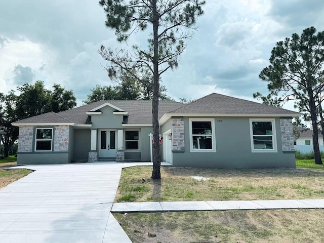 505 Shanklin Ave, Bartow, FL 33830 - ranch-style house with french doors, stucco siding, driveway, and stone siding