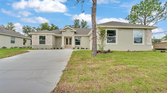 505 Shanklin Ave, Bartow, FL 33830 - ranch-style house with driveway, stone siding, french doors, a front lawn, and stucco siding