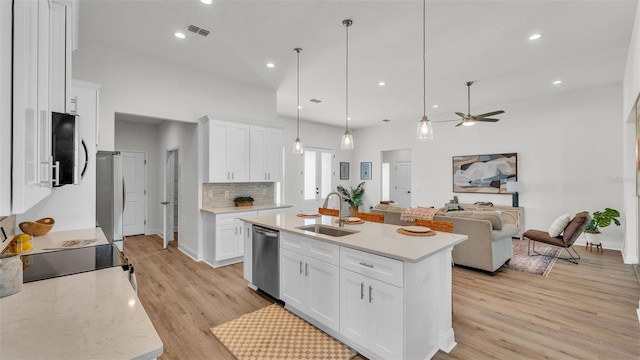 505 Shanklin Ave, Bartow, FL 33830 - kitchen with stainless steel appliances, ceiling fan, open floor plan, light wood finished floors, and white cabinets