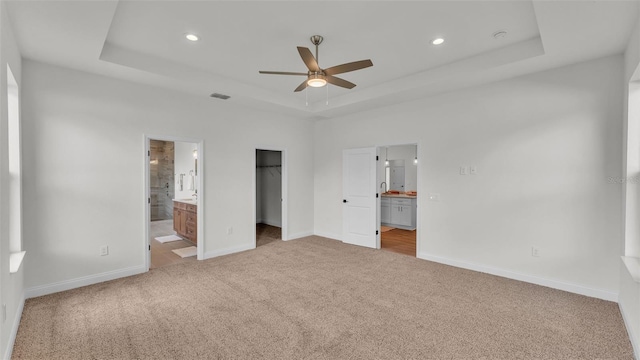 505 Shanklin Ave, Bartow, FL 33830 - unfurnished bedroom with carpet floors, a raised ceiling, connected bathroom, a spacious closet, and recessed lighting