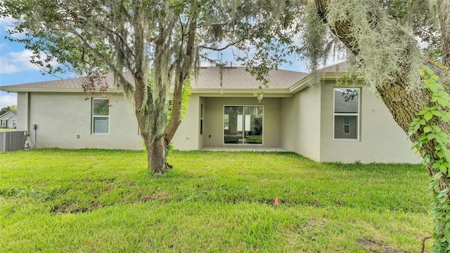 505 Shanklin Ave, Bartow, FL 33830 - back of property with stucco siding, a yard, a patio area, and roof with shingles