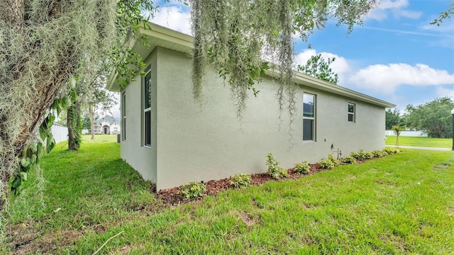 505 Shanklin Ave, Bartow, FL 33830 - view of property exterior with stucco siding and a yard