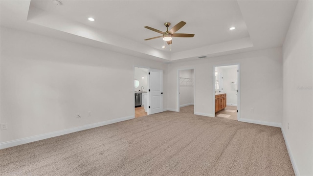 803 Allison Pl, Bartow, FL 33830 - unfurnished bedroom with a tray ceiling, light carpet, ensuite bathroom, and recessed lighting