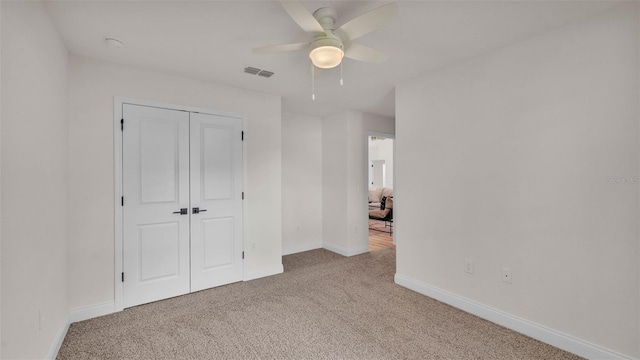 803 Allison Pl, Bartow, FL 33830 - unfurnished bedroom with carpet, a closet, and a ceiling fan