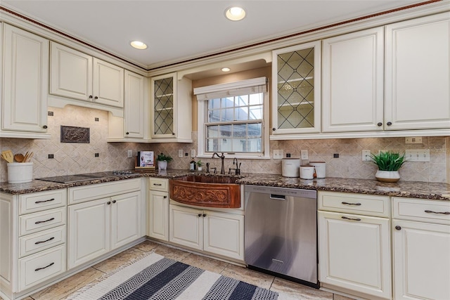 3906 Canyon Lake Pt, Lakeland, FL 33813 - kitchen with stainless steel dishwasher, decorative backsplash, a sink, and dark stone counters