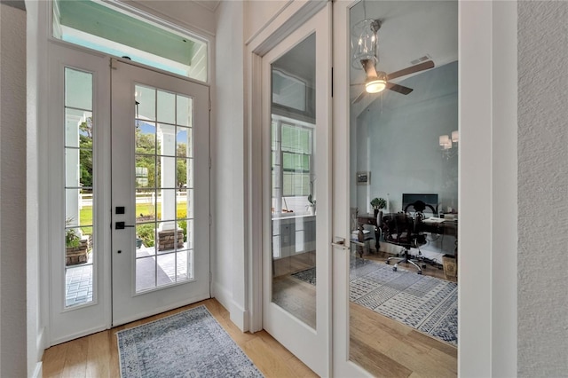 9004 Selph Rd, Lakeland, FL 33810 - doorway to outside featuring french doors, a ceiling fan, and light wood-style flooring
