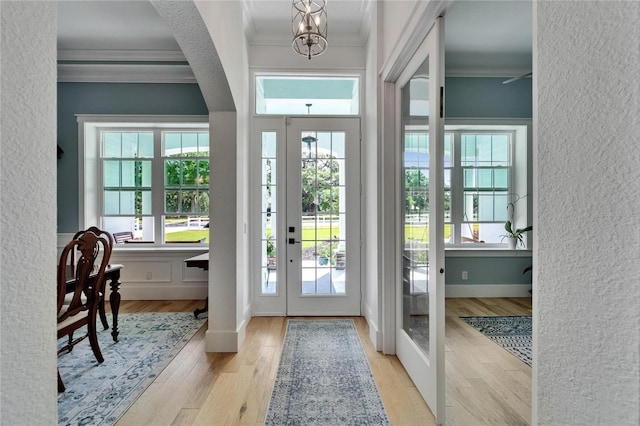 9004 Selph Rd, Lakeland, FL 33810 - entryway featuring crown molding, plenty of natural light, an inviting chandelier, and wood finished floors