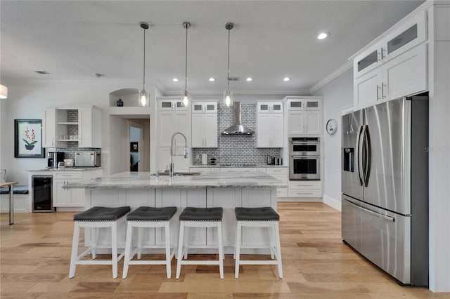 9004 Selph Rd, Lakeland, FL 33810 - kitchen with crown molding, wall chimney exhaust hood, a sink, beverage cooler, and stainless steel appliances