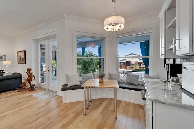 9004 Selph Rd, Lakeland, FL 33810 - doorway featuring light wood-style flooring, crown molding, french doors, and an inviting chandelier