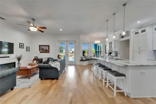 9004 Selph Rd, Lakeland, FL 33810 - living room with light wood-style flooring, visible vents, ornamental molding, and a ceiling fan