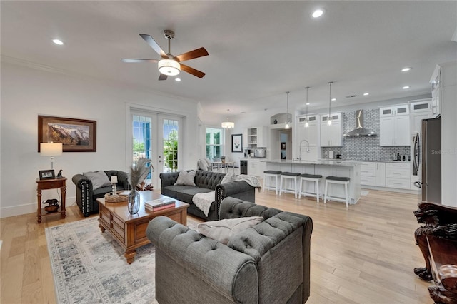 9004 Selph Rd, Lakeland, FL 33810 - living room with crown molding, ceiling fan, recessed lighting, light wood finished floors, and baseboards