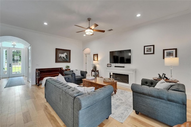 9004 Selph Rd, Lakeland, FL 33810 - living area with ornamental molding, light wood-style flooring, recessed lighting, and arched walkways