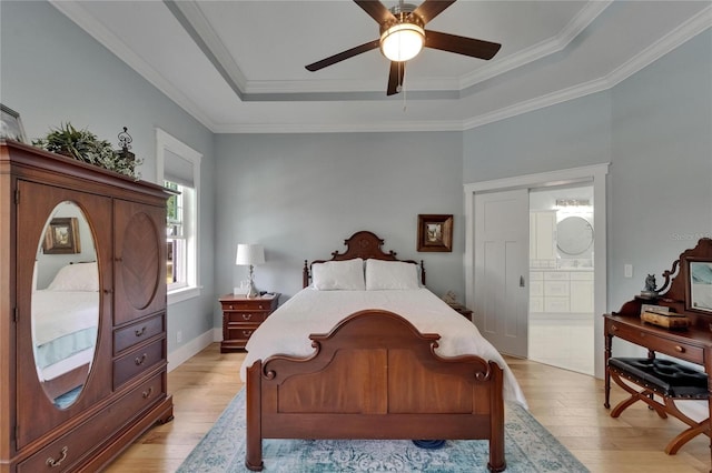 9004 Selph Rd, Lakeland, FL 33810 - bedroom featuring ensuite bathroom, crown molding, a ceiling fan, a tray ceiling, and light wood finished floors