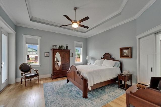 9004 Selph Rd, Lakeland, FL 33810 - bedroom with multiple windows, light wood-type flooring, and a raised ceiling